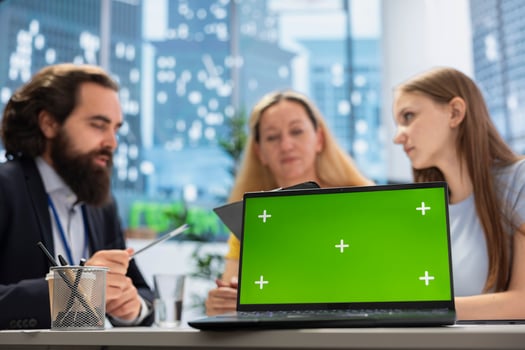 Financial advisor works with clients to create long term investment strategies, using green screen laptop. Agent helps family set realistic financial goals and roadmap using chroma key notebook photo