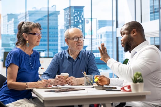 Senior people exploring retirement plans with a financial adviser, discussing about pension and life savings. Elderly couple looking to invest and secure their finances for the future. photo