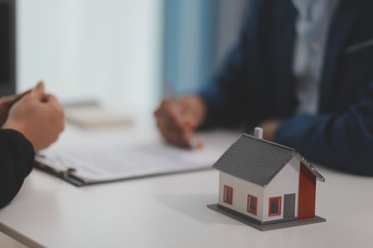 Estate agent giving house keys to client after signing agreement contract real estate with approved mortgage application form, concerning mortgage loan offer for and house insurance. photo