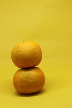 Orange Fruit and mango fruit on a Yellow table. photo