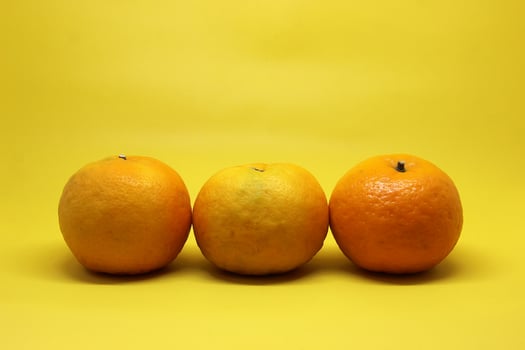 Orange Fruit and mango fruit on a Yellow table. photo