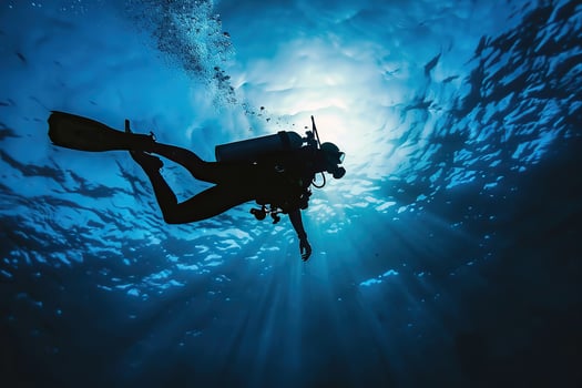 Scuba diver goes on underwater adventure among the deep scary blue sea photo