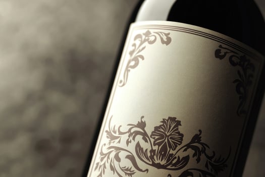 A close-up of a wine bottle label with a blank space beside it. photo