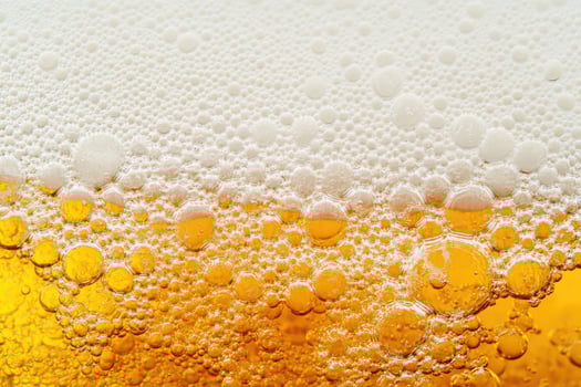 Beer banner with a close-up of beer bubbles and space for text. photo