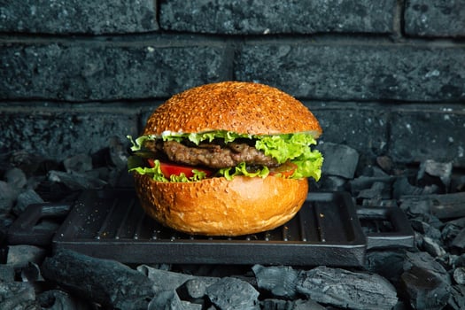 Cheeseburger on a Grill Over Charcoal photo
