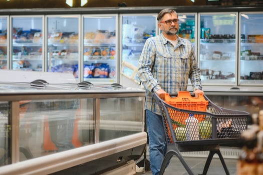 Senior man at grocery store products photo