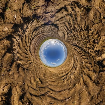 blue hole sphere or globe little planet inside sand or dry ground frame background with tractor tracks photo