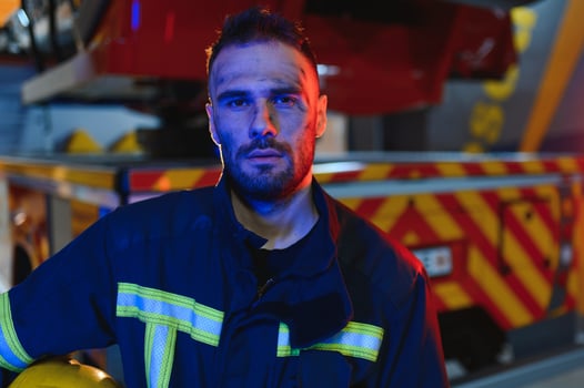Photo of fireman with gas mask and helmet near fire engine