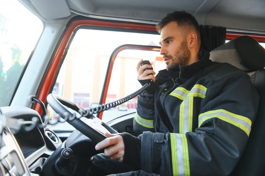 Firefighter drives a emergency vehicle with communication interior view photo