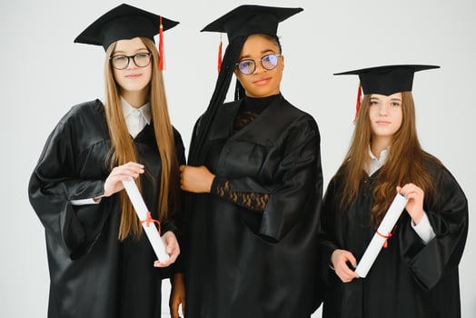 Pretty female college graduate at graduation with classmates photo