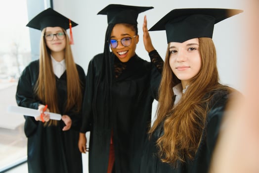 portrait of multiracial graduates holding diploma photo