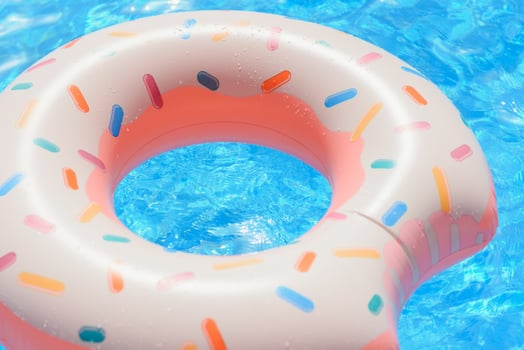 Inflatable swim ring in shape of donut floating in pool photo