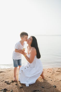 happy mother with son walk on beach, family at sea photo