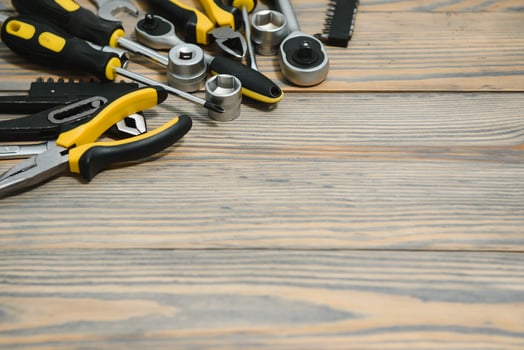 Different construction tools on a wooden background with copy space photo