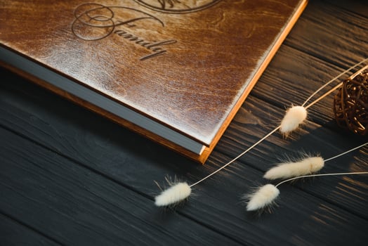 Luxury wooden photo book on natural background. Family memories photobook. Save your summer vacation memories.