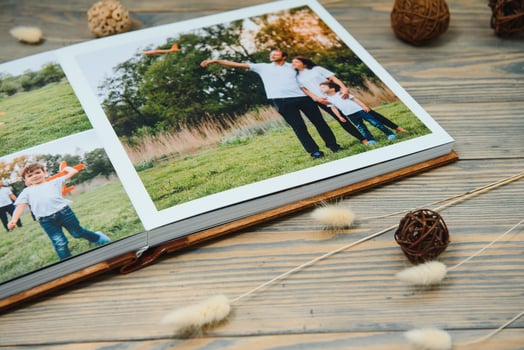 Luxury wooden photo book on natural background. Family memories photobook. Save your summer vacation memories.