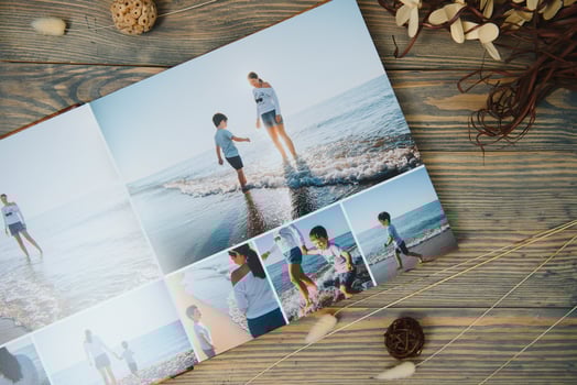Luxury wooden photo book on natural background. Family memories photobook. Save your summer vacation memories.