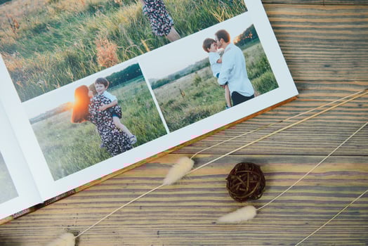 Luxury wooden photo book on natural background. Family memories photobook. Save your summer vacation memories.