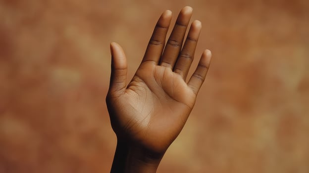 Hand Raised Against Warm Background Signifying Openness and Communication During Late Afternoon Light photo