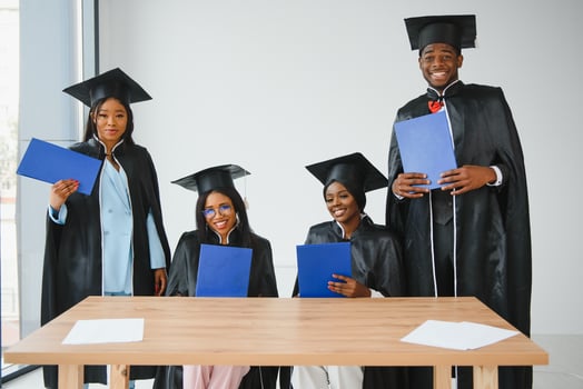portrait of multiracial graduates holding diploma photo