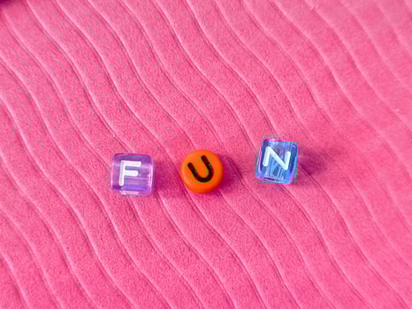 The word www formed with multicolored plastic cubes on pink background photo