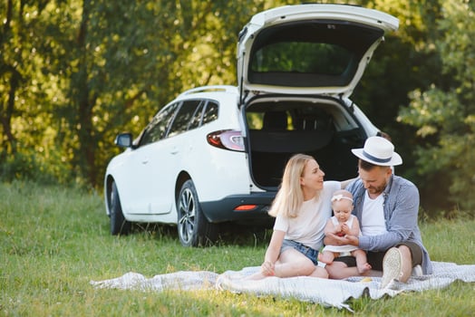 Family in a forest. People by the car. Sunset background. photo
