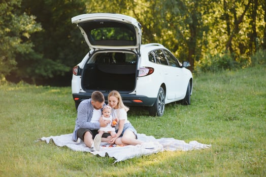 Family in a forest. People by the car. Sunset background. photo