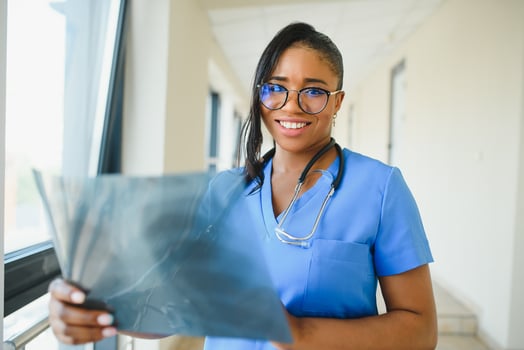 african doctor looking at patient's x-ray at hospital photo