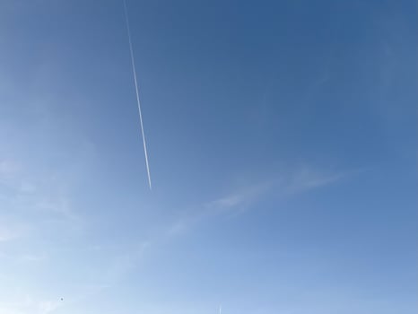 Flight path in the blear blue sky photo