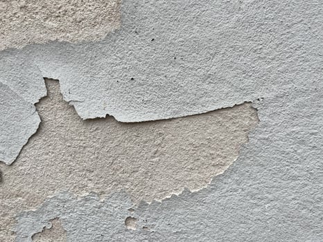 Close up at peeling paint on concrete wall textures. The walls are peeling because the paint is old and needs to be repaired and repainted photo