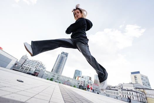 Dynamic Urban Dance Performance by Female Dancer in City Plaza During Bright Daylight photo