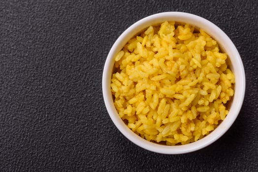 Delicious boiled yellow rice with turmeric, salt and spices photo