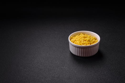 Delicious boiled yellow rice with turmeric, salt and spices photo
