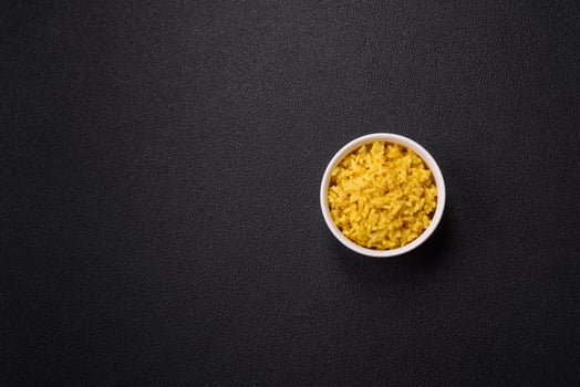 Delicious boiled yellow rice with turmeric, salt and spices photo