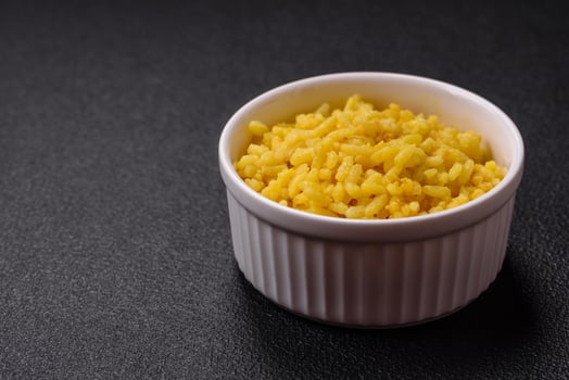 Delicious boiled yellow rice with turmeric, salt and spices photo