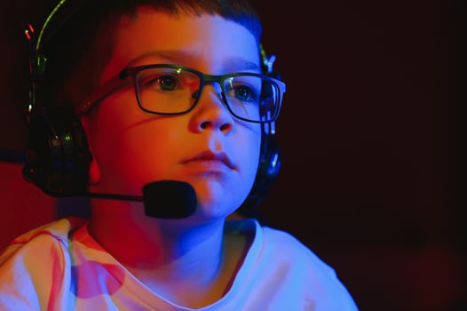 Boy in the headphones is playing a game. photo