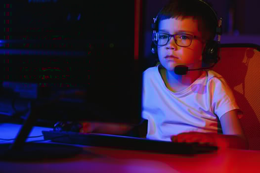 Boy in the headphones is playing a game. photo