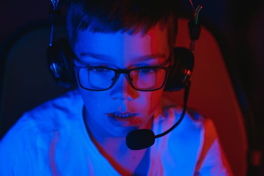 Boy in the headphones is playing a game. photo