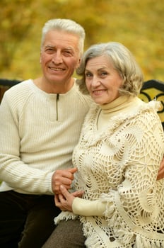 Mature couple walking in the autumn park photo
