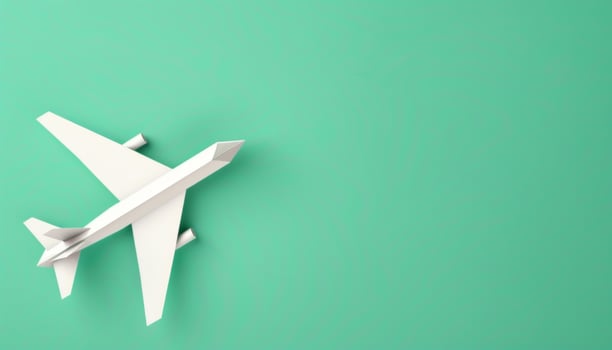 Origami Airplane for Travel Concept. Paper Airplane Model on Green Background with Copy Space photo