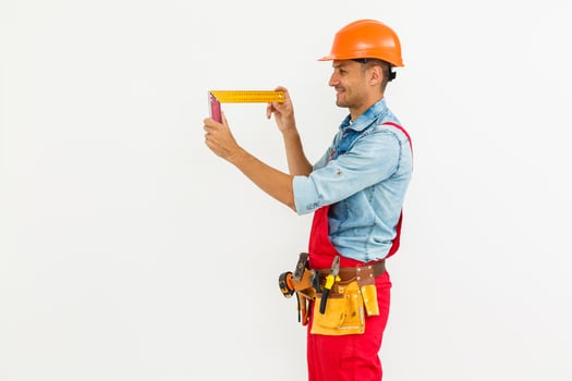 profession, construction and building - happy smiling male worker or builder in helmet over white background. photo