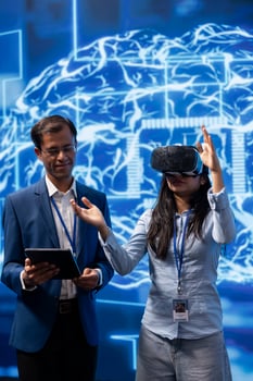 Expert doing VR demonstration at AI tech summit event gathering professionals seeking to discover latest innovations. Man presents how can AI and virtual reality be leveraged to accelerate innovation photo