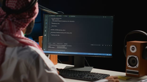 Certified arab engineer writing code on computer screen while in office using Java programming languages. Middle Eastern developer working on fixing database errors while working from apartment office photo