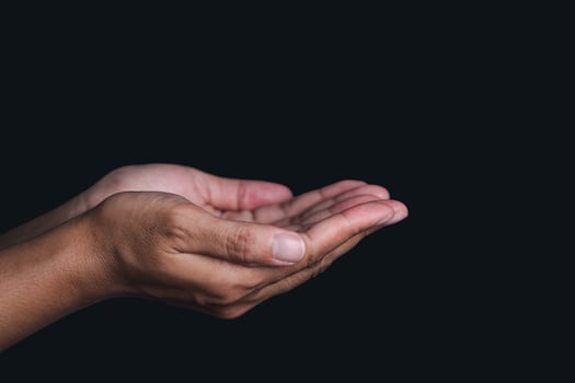 Hands isolated on black background. Hands concept. Outstretched hand. Side view. Dark background photo