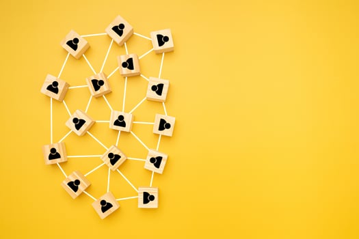 Network, Teamwork, and unity concept. Top view of wooden blocks with black human icons laid scattered on a yellow background, Flat lay, space for text photo