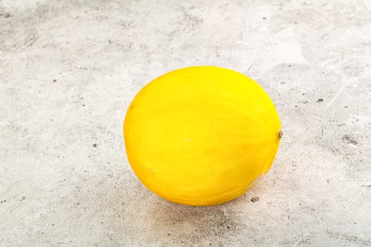 Sweet juicy whole yellow melon photo