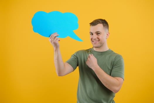 Young caucasian man isolated on yellow background holding a thinking speech bubble and doing OK sign photo