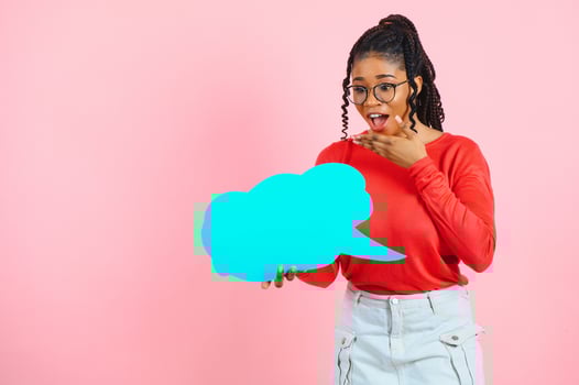 Place For Text. Happy black woman pointing at white advertisement board isolated over pink wall, copyspace. photo