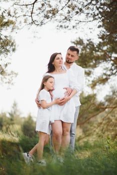 Pregnant woman with her family looking happy photo
