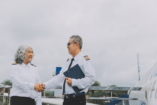Professional pilot woman in uniform has teamwork meeting for success flight in aviation business. Young female captain instructor sitting in office and working or training commercial airline crew. photo